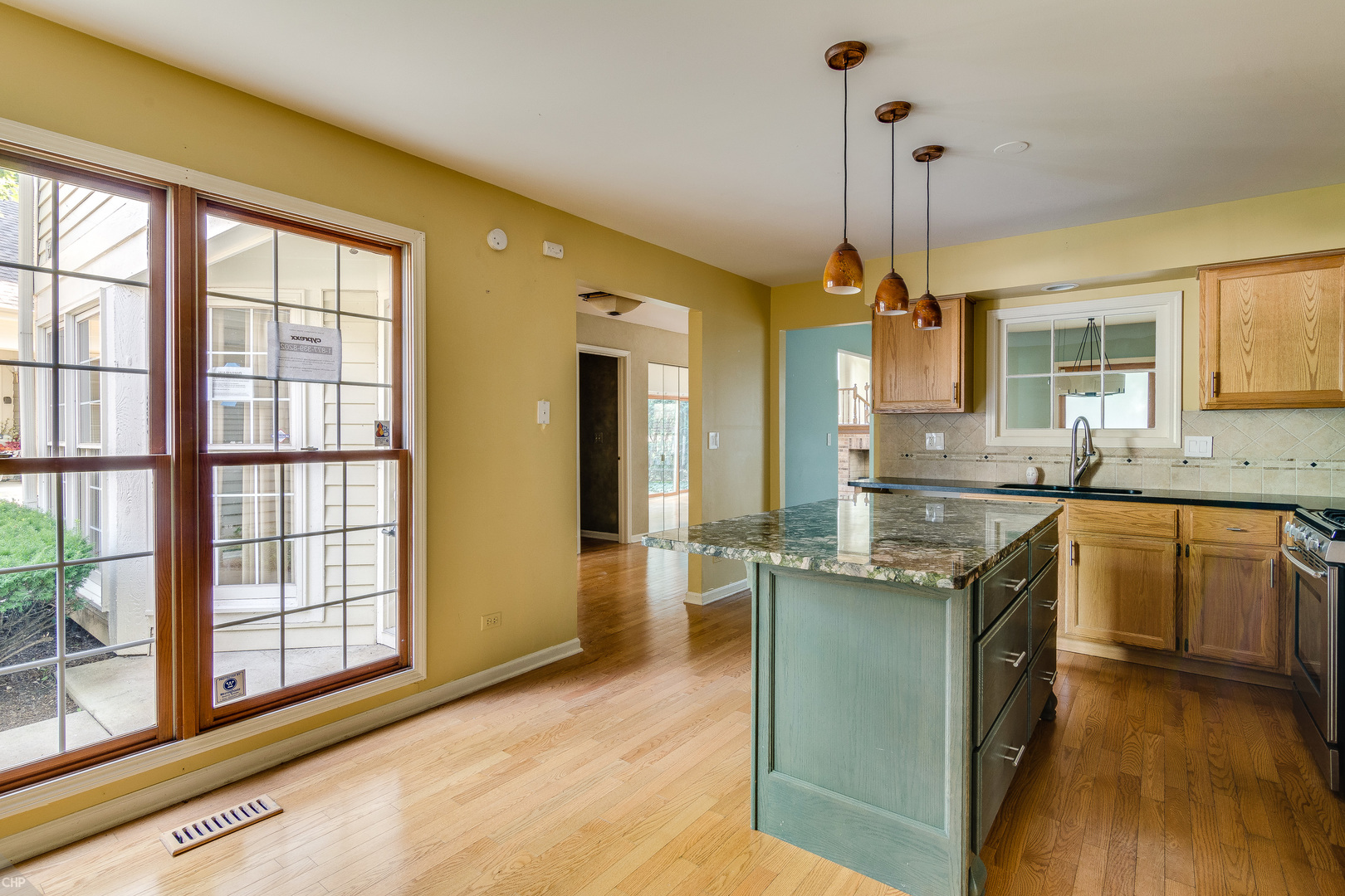 310 Spring Creek Circle Schaumburg, IL 60173 - Photo 8 of 26 a kitchen with stainless steel appliances granite countertop a sink a stove and a wooden floors