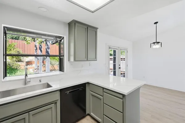 a kitchen with a sink and large window