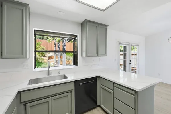 a kitchen with a sink cabinets and window