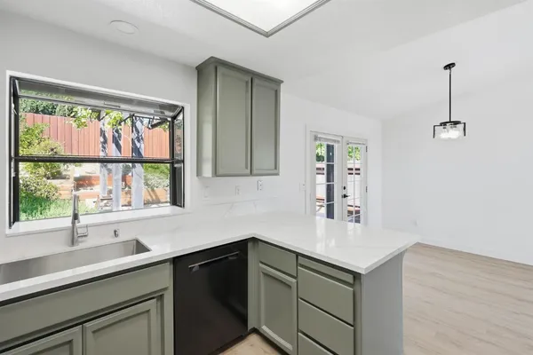 a kitchen with a sink and large window