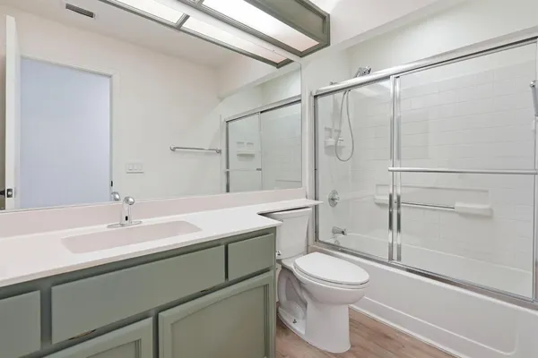 a bathroom with a sink toilet and shower