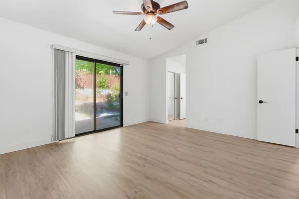 wooden floor in an empty room with a window