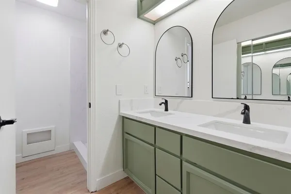 a bathroom with a double vanity sink and a mirror