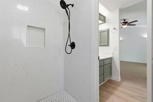 a bathroom with a shower and a sink