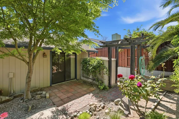 a front view of a house with a yard and a garden