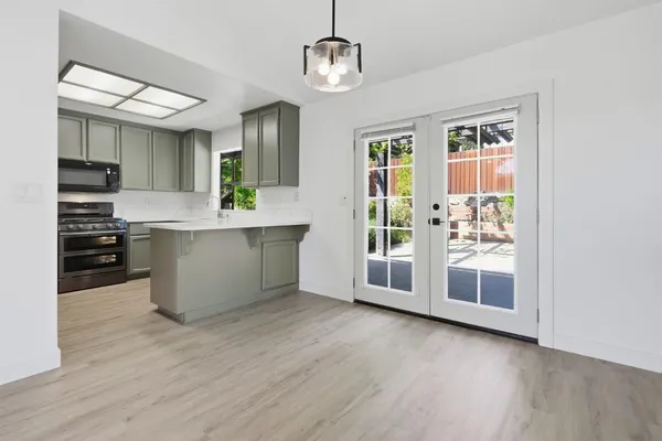 a view of a kitchen with furniture wooden floor and window