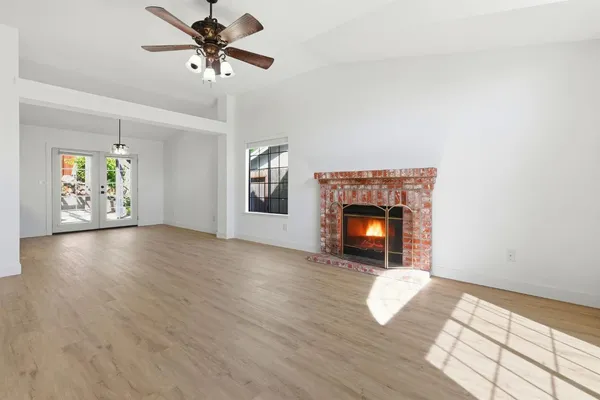 a view of a room window and wooden floor