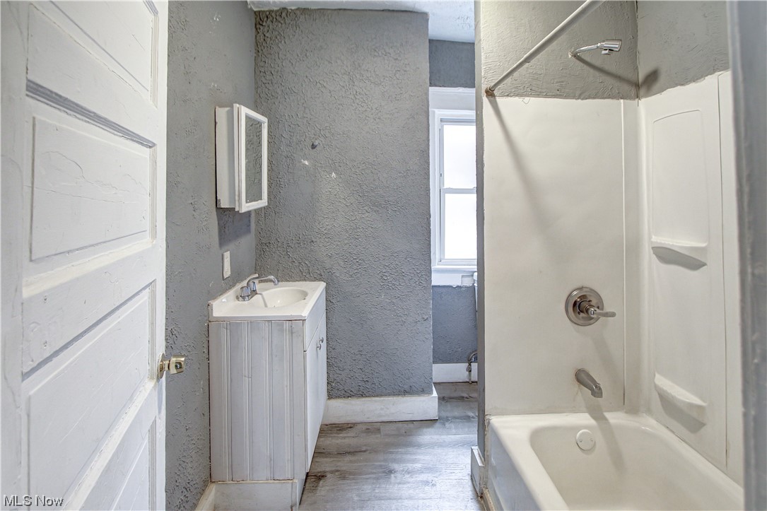3816 Riverside Avenue Cleveland, OH 44109 - Photo 11 of 35 Bathroom with vanity, shower / tub combination, mirror, and light hardwood flooring