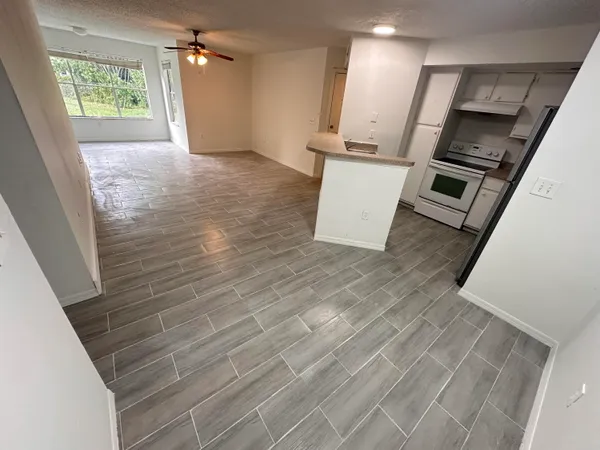 a kitchen with kitchen island a sink appliances and cabinets