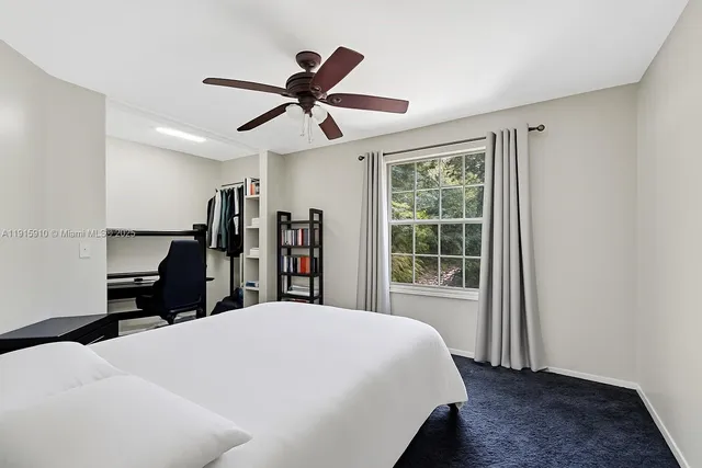 an aerial view of a houses with a lake