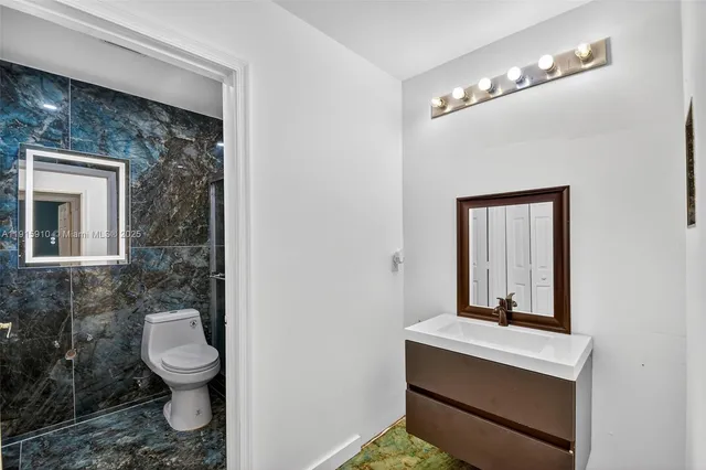 a view of a house with a yard and potted plants