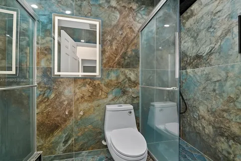 view of a swimming pool with a garden and trees