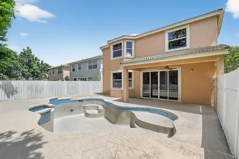 a view of a patio with swimming pool table and chairs
