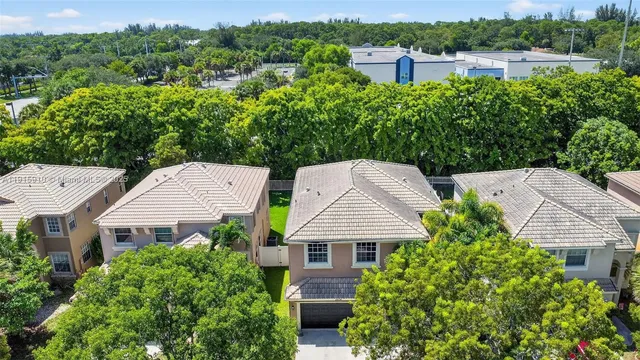 an aerial view of residential houses with outdoor space and lake view