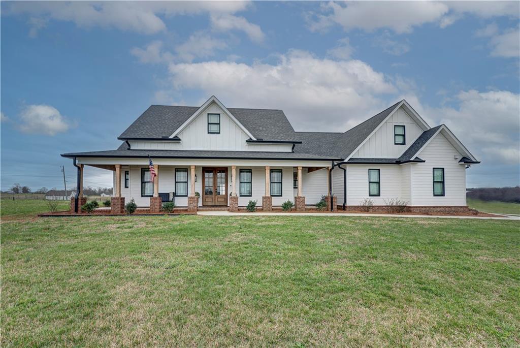 2453 Boone Ford Road Southeast Calhoun, GA 30701 - Photo 1 of 135 a front view of a house with swimming pool having outdoor seating