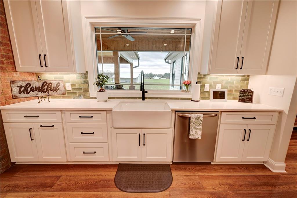 2453 Boone Ford Road Southeast Calhoun, GA 30701 - Photo 36 of 135 a kitchen with stainless steel appliances granite countertop a sink a stove and cabinets