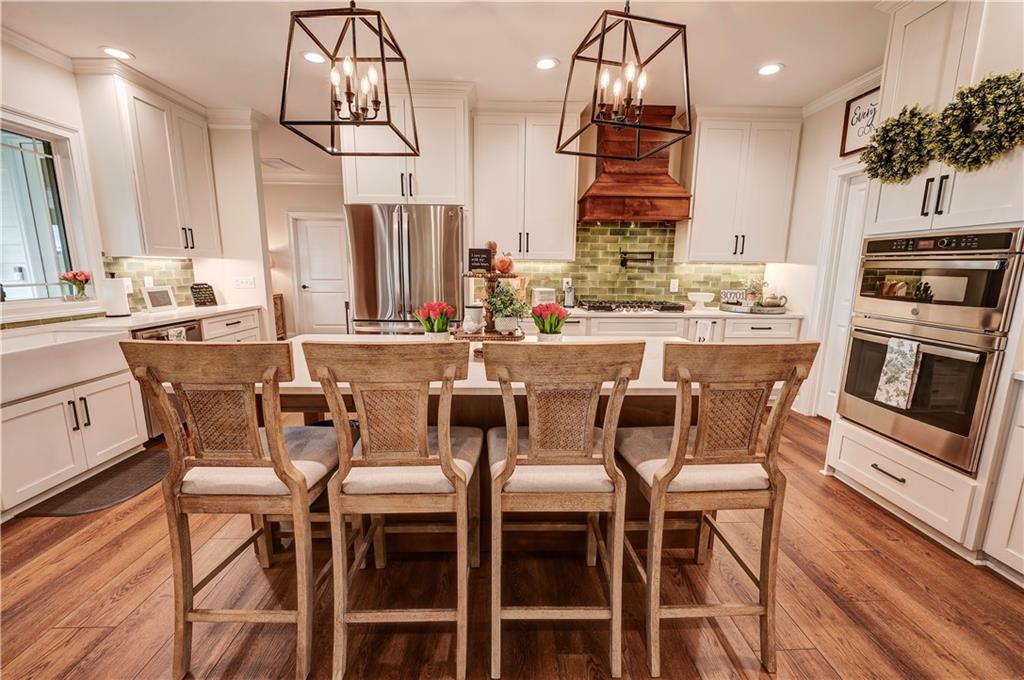 2453 Boone Ford Road Southeast Calhoun, GA 30701 - Photo 41 of 135 a dining room with stainless steel appliances kitchen island granite countertop a dining table chairs and granite counter tops