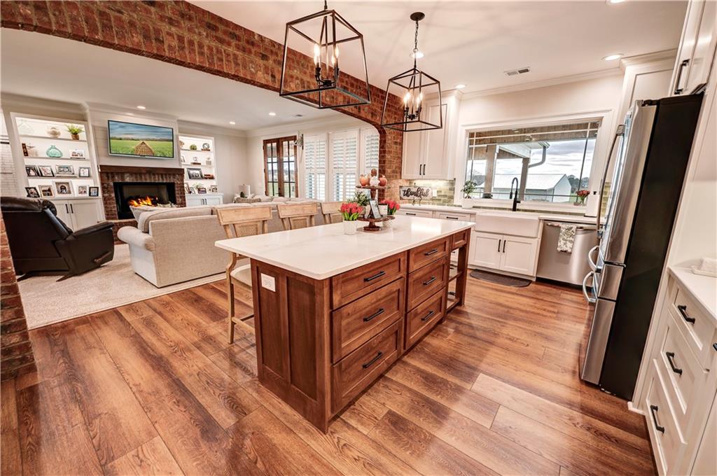2453 Boone Ford Road Southeast Calhoun, GA 30701 - Photo 44 of 135 a large kitchen with stainless steel appliances granite countertop a lot of counter space and wooden floors