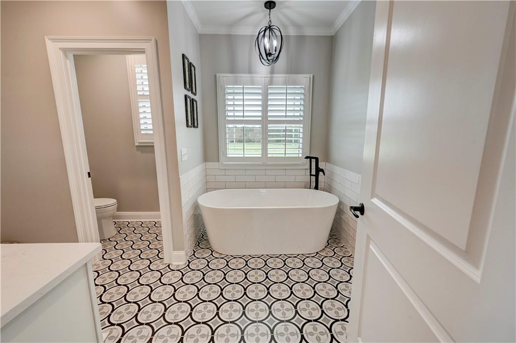 2453 Boone Ford Road Southeast Calhoun, GA 30701 - Photo 61 of 135 a bathroom with a bathtub a shower and a window