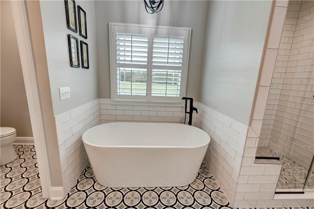 2453 Boone Ford Road Southeast Calhoun, GA 30701 - Photo 62 of 135 a white bath tub sitting in a bathroom next to a window