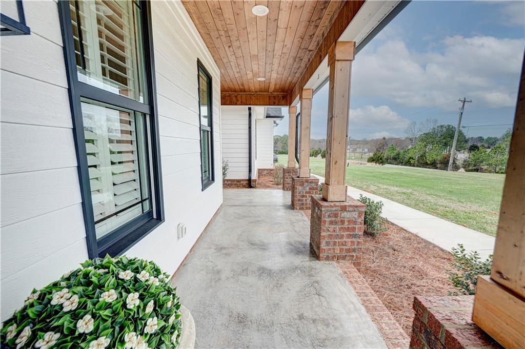 2453 Boone Ford Road Southeast Calhoun, GA 30701 - Photo 86 of 135 a view of a porch with chairs and a yard