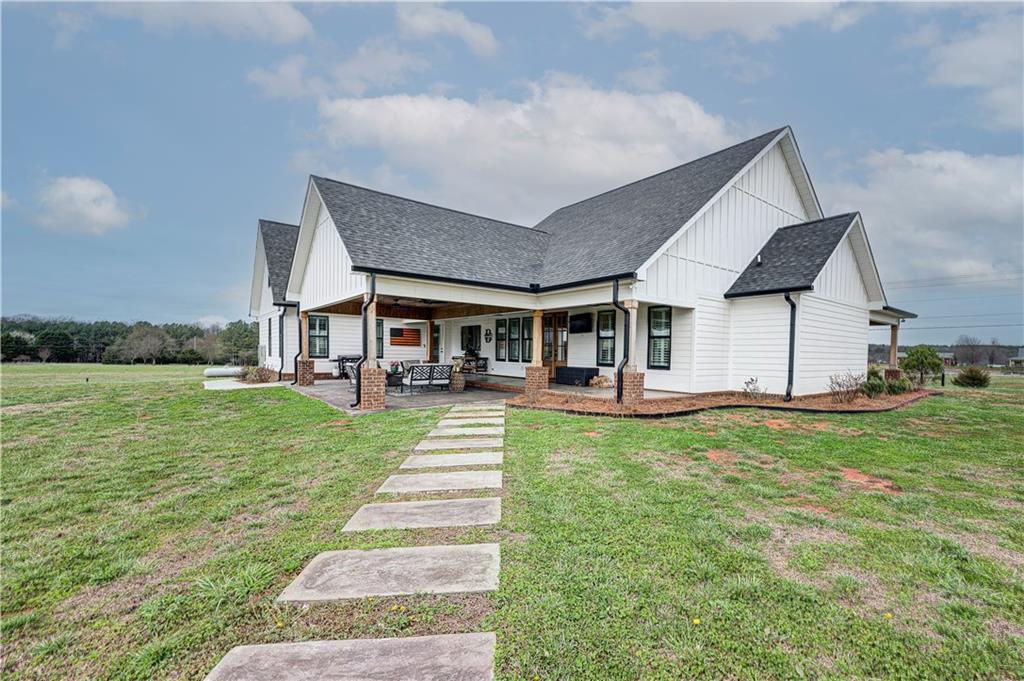 2453 Boone Ford Road Southeast Calhoun, GA 30701 - Photo 100 of 135 a front view of a house with a yard table and chairs