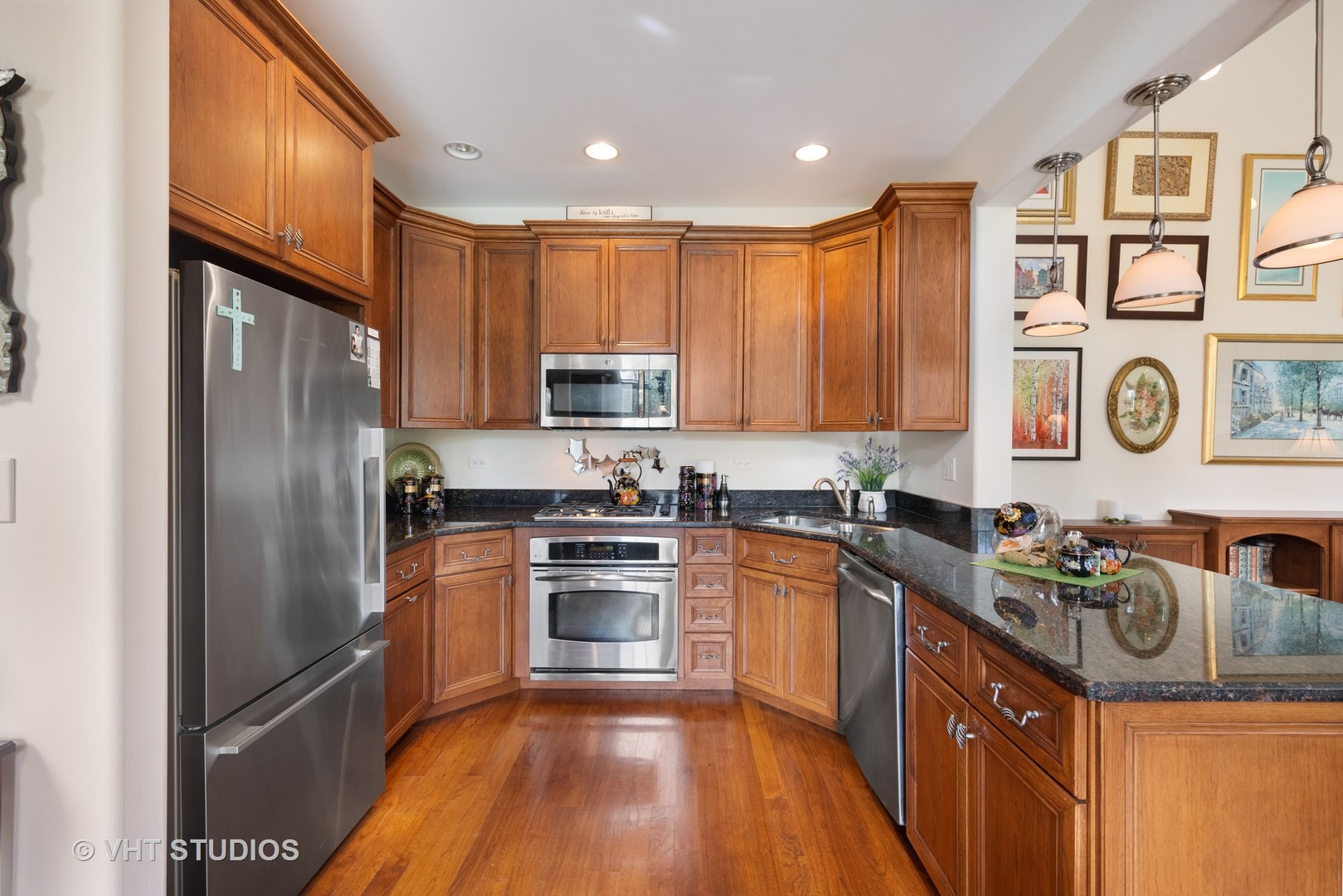 1001 Stacia Lane Lemont, IL 60439 - Photo 11 of 36 a kitchen with stainless steel appliances granite countertop a stove top oven a refrigerator a sink and dishwasher with wooden floor