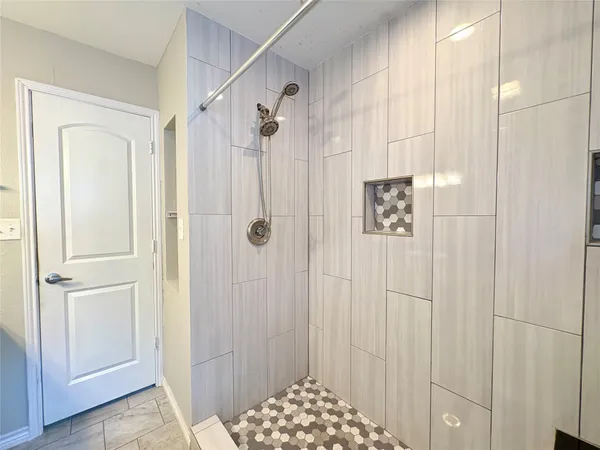 a bathroom with a shower and a sink