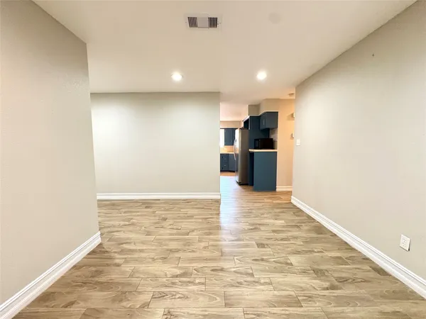 a view of a kitchen with a sink and a refrigerator