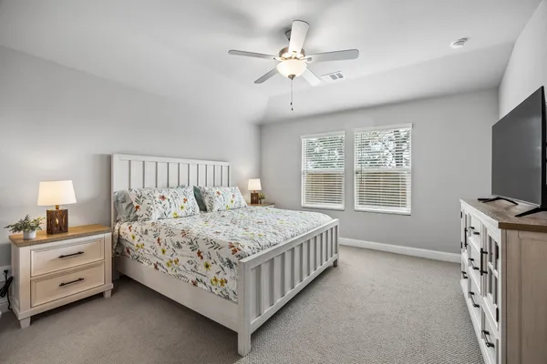 a bedroom with a bed and a chandelier