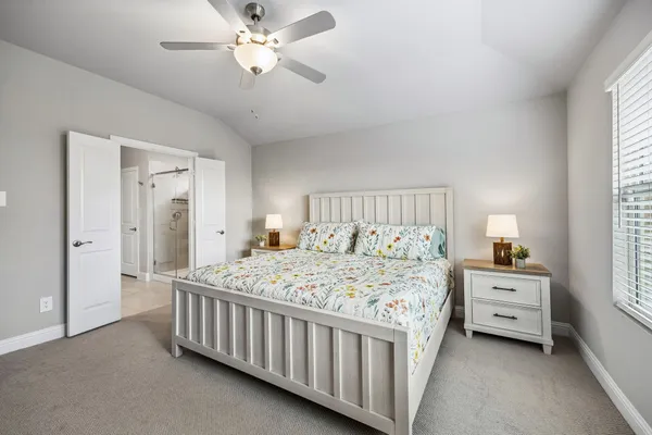 a bedroom with a large bed and a flat screen tv
