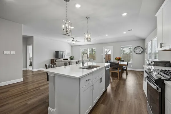 a kitchen with a sink stove and microwave