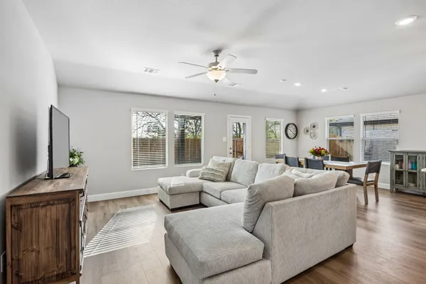 a living room with furniture and kitchen view