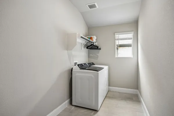 a bedroom with a bed and a flat tv screen on the dresser