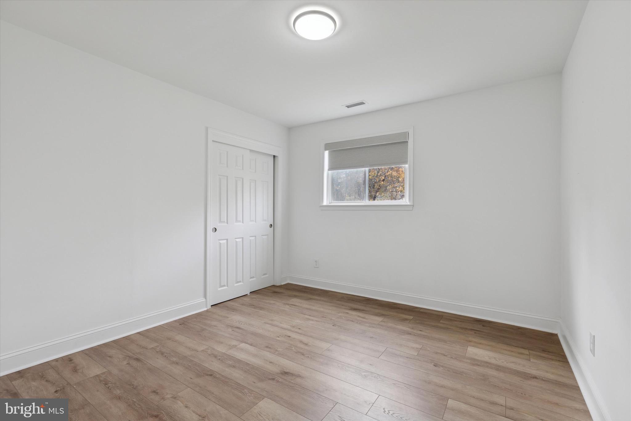3023 Eisenhower Road Norristown, PA 19403 - Photo 9 of 22 an empty room with wooden floor and windows