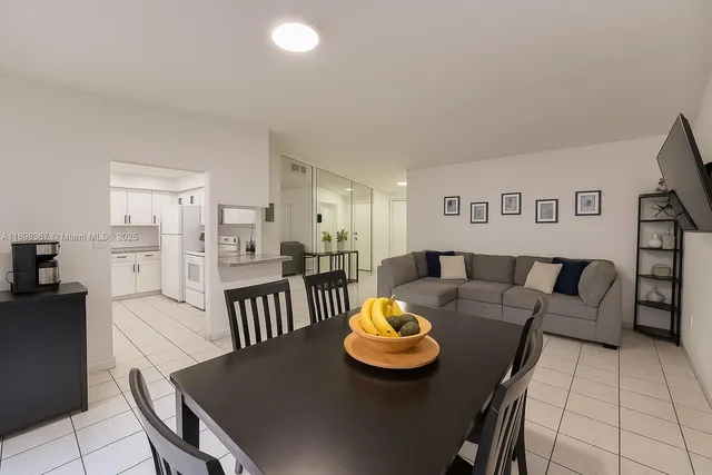 a living room with furniture and kitchen view