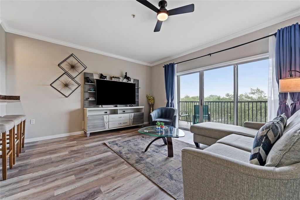 14200 Avalon Road, Unit 409 Winter Garden, FL 34787 - Photo 5 of 33 a living room with furniture and a flat screen tv