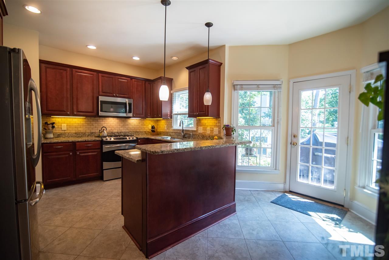 9716 Talman Court Raleigh, NC 27615 - Photo 13 of 30 Granite countertops make meal prep a breeze.