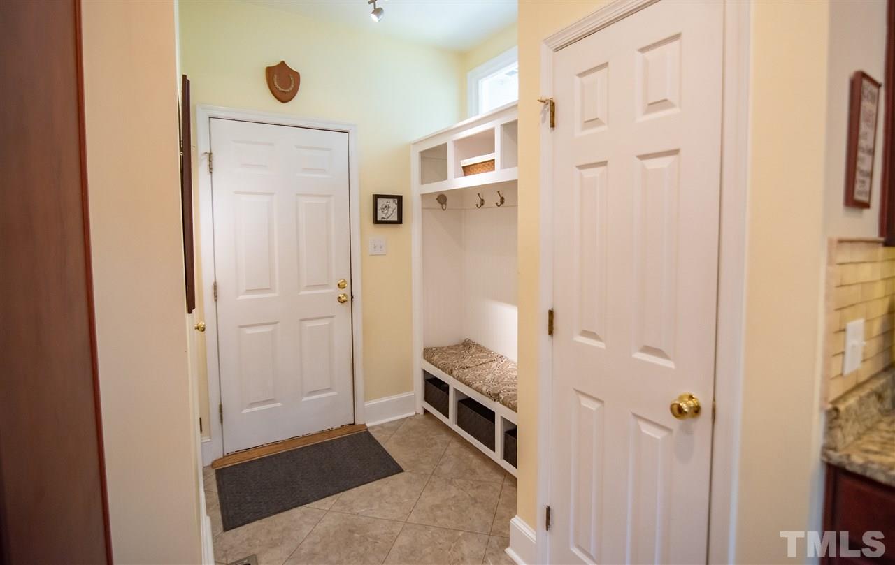 9716 Talman Court Raleigh, NC 27615 - Photo 16 of 30 Conveniently located off of the garage, this mudroom features a sectioned bench with storage. Perfect for coats, backpacks or shoes.