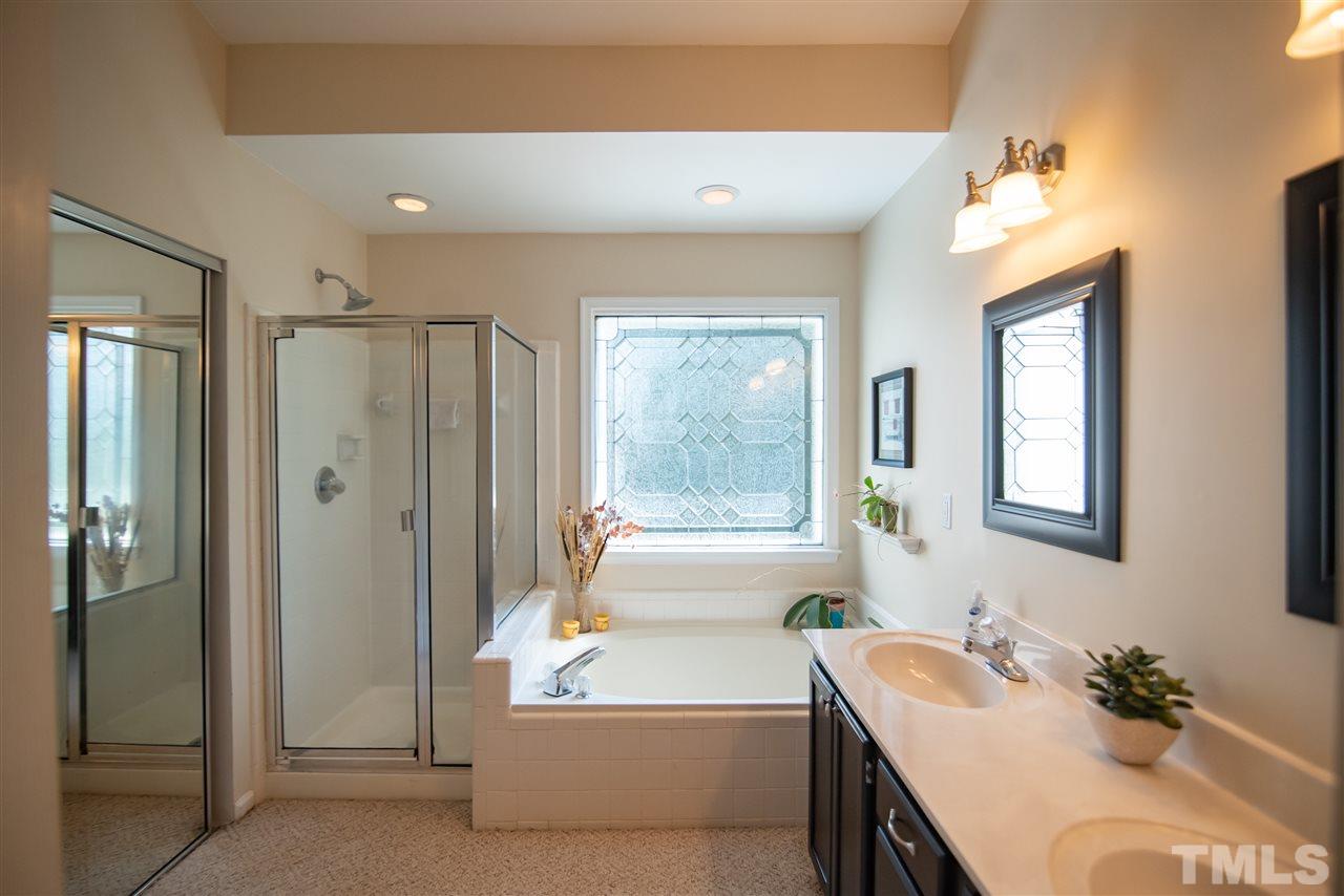 9716 Talman Court Raleigh, NC 27615 - Photo 20 of 30 This sanctuary features garden tub, separate shower and double sink vanity.