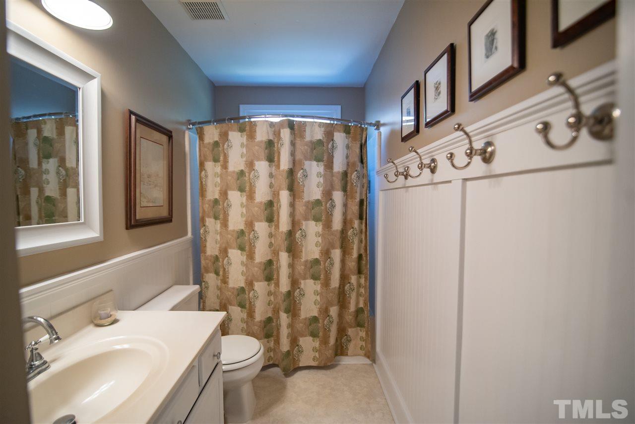 9716 Talman Court Raleigh, NC 27615 - Photo 22 of 30 Hall bath features tub/shower combo and vanity.