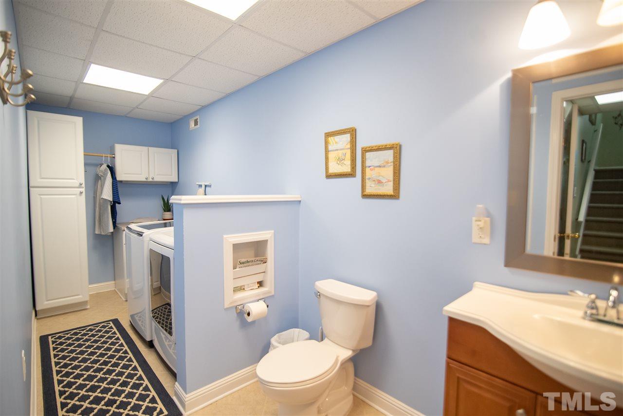 9716 Talman Court Raleigh, NC 27615 - Photo 26 of 30 Features a 1/2 bath and laundry organization.