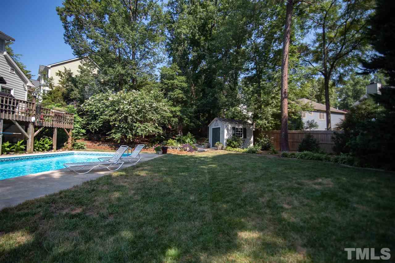 9716 Talman Court Raleigh, NC 27615 - Photo 30 of 30 Fenced in wooded lot features large storage shed.