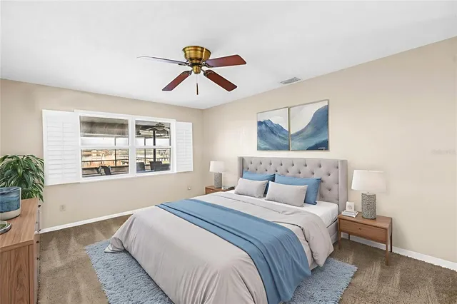 a bedroom with a large bed and a chandelier