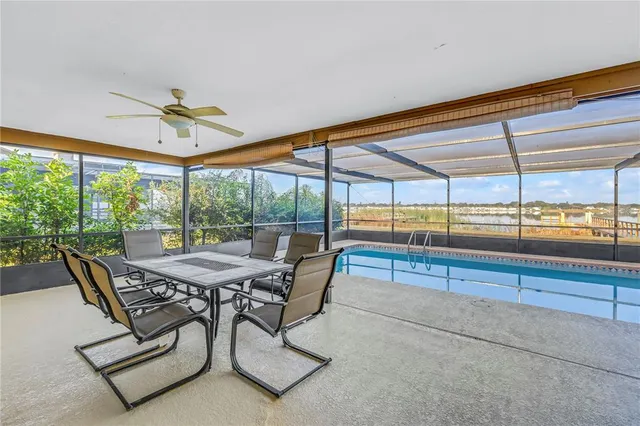 a dining room with furniture and a floor to ceiling window