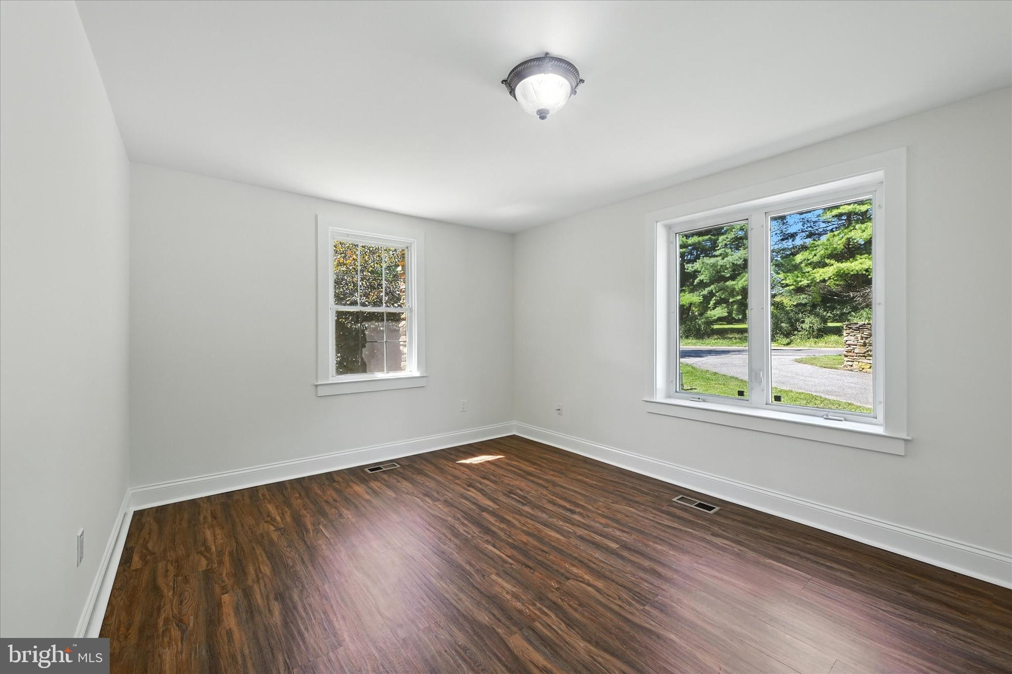 12325 Falls Road Cockeysville, MD 21030 - Photo 25 of 40 a view of an empty room with wooden floor and a window