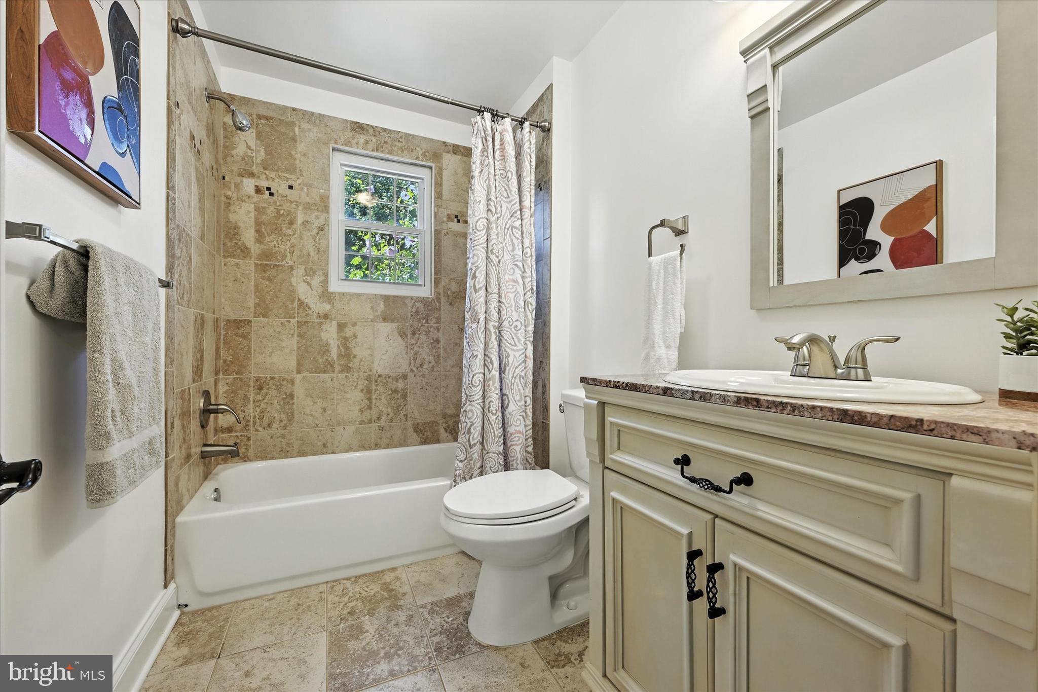 12325 Falls Road Cockeysville, MD 21030 - Photo 29 of 40 a bathroom with a granite countertop toilet a sink and a bathtub