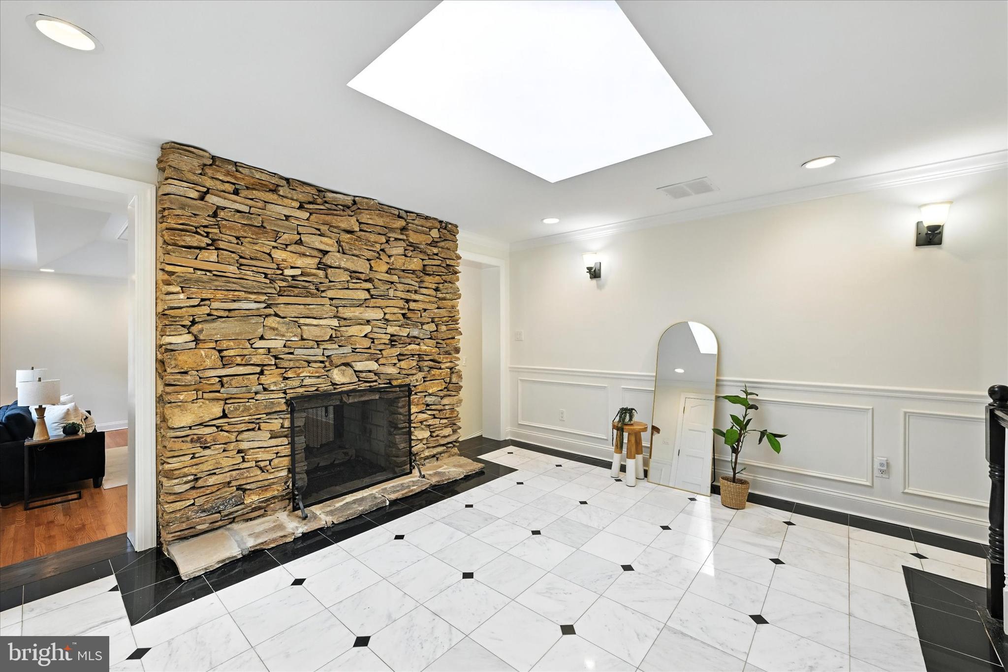 12325 Falls Road Cockeysville, MD 21030 - Photo 4 of 40 a living room with furniture a fireplace and a flat screen tv