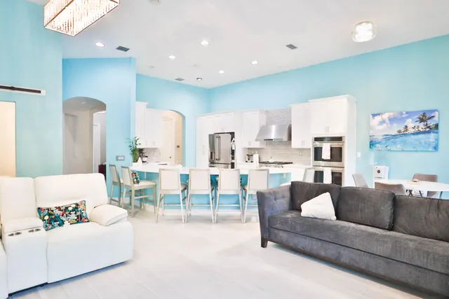 a living room with furniture and kitchen view