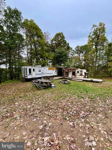 a view of a house with a yard table and chairs